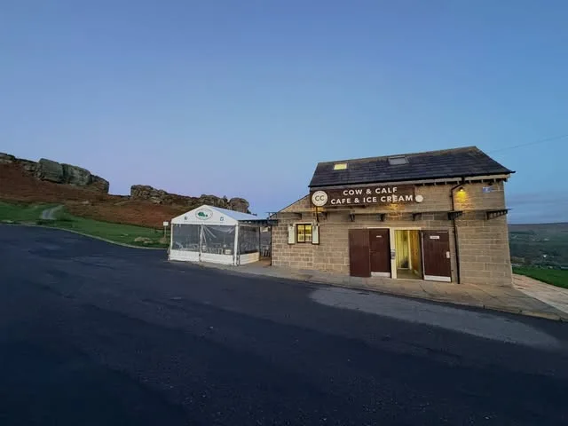 The cafe lights on as the day draws to a close beside the rocks